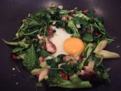 Kate's stir-fried in coconut oil leafy vegetables with egg on thrivelowcarb.com